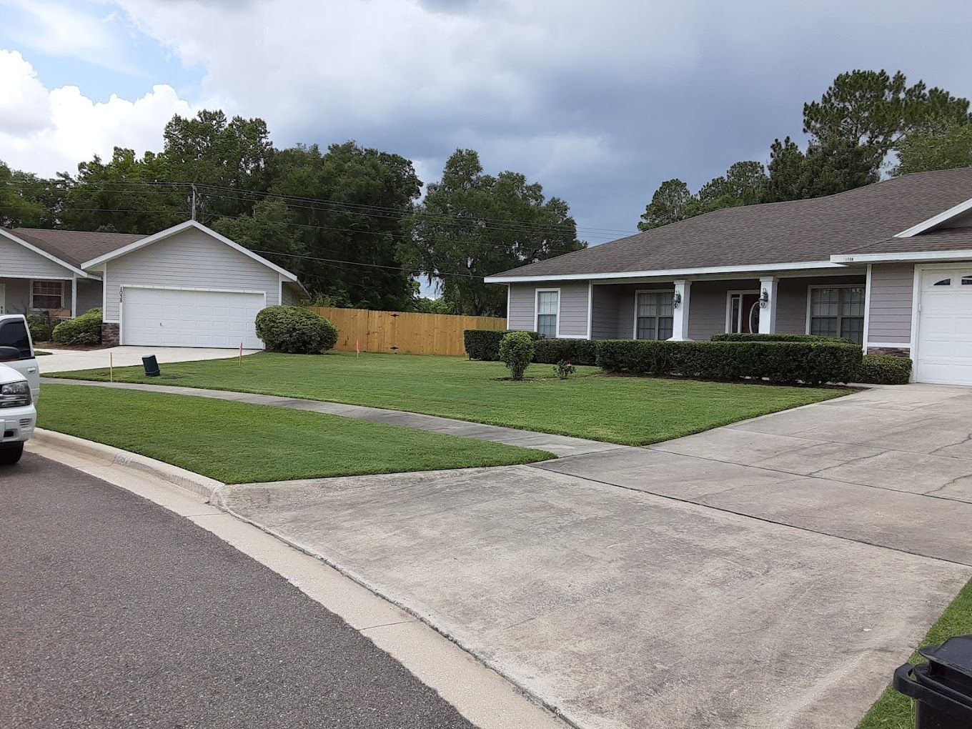 A white truck is parked in front of a house