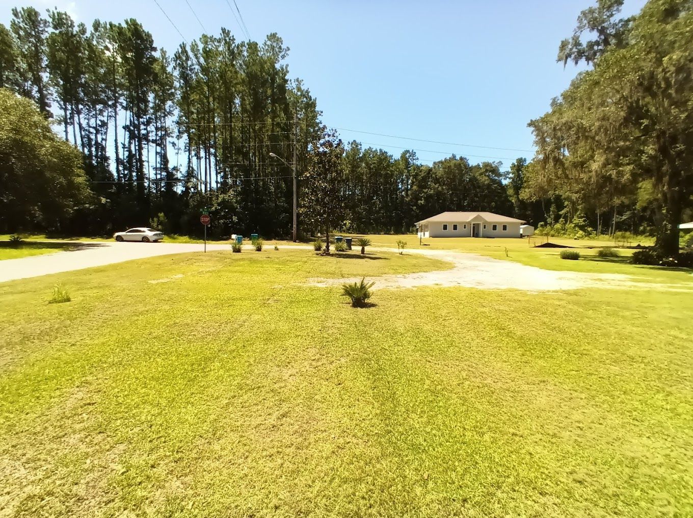 A house sits in the middle of a lush green field