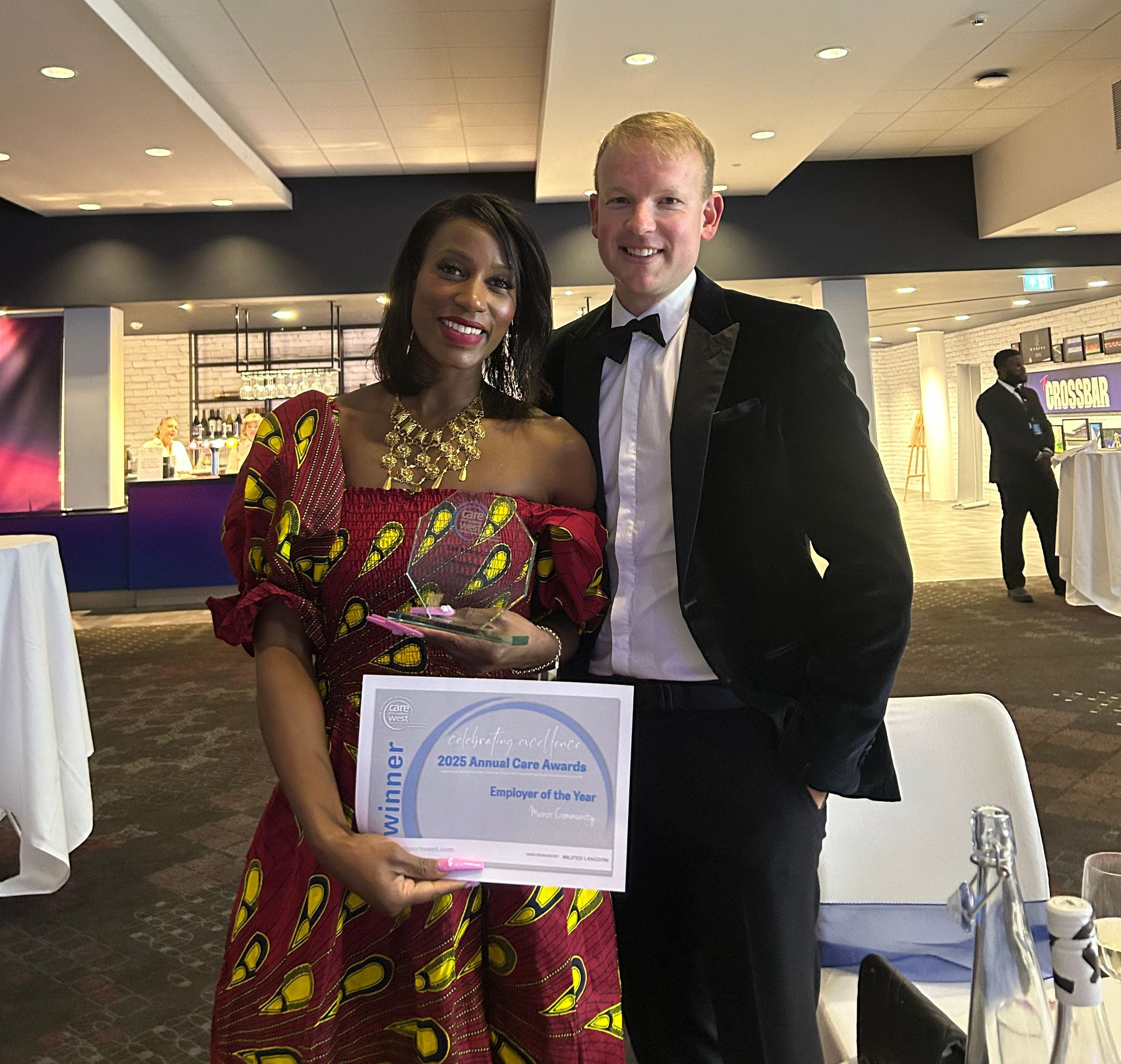 Smiling, holding award after. Wining a care award!