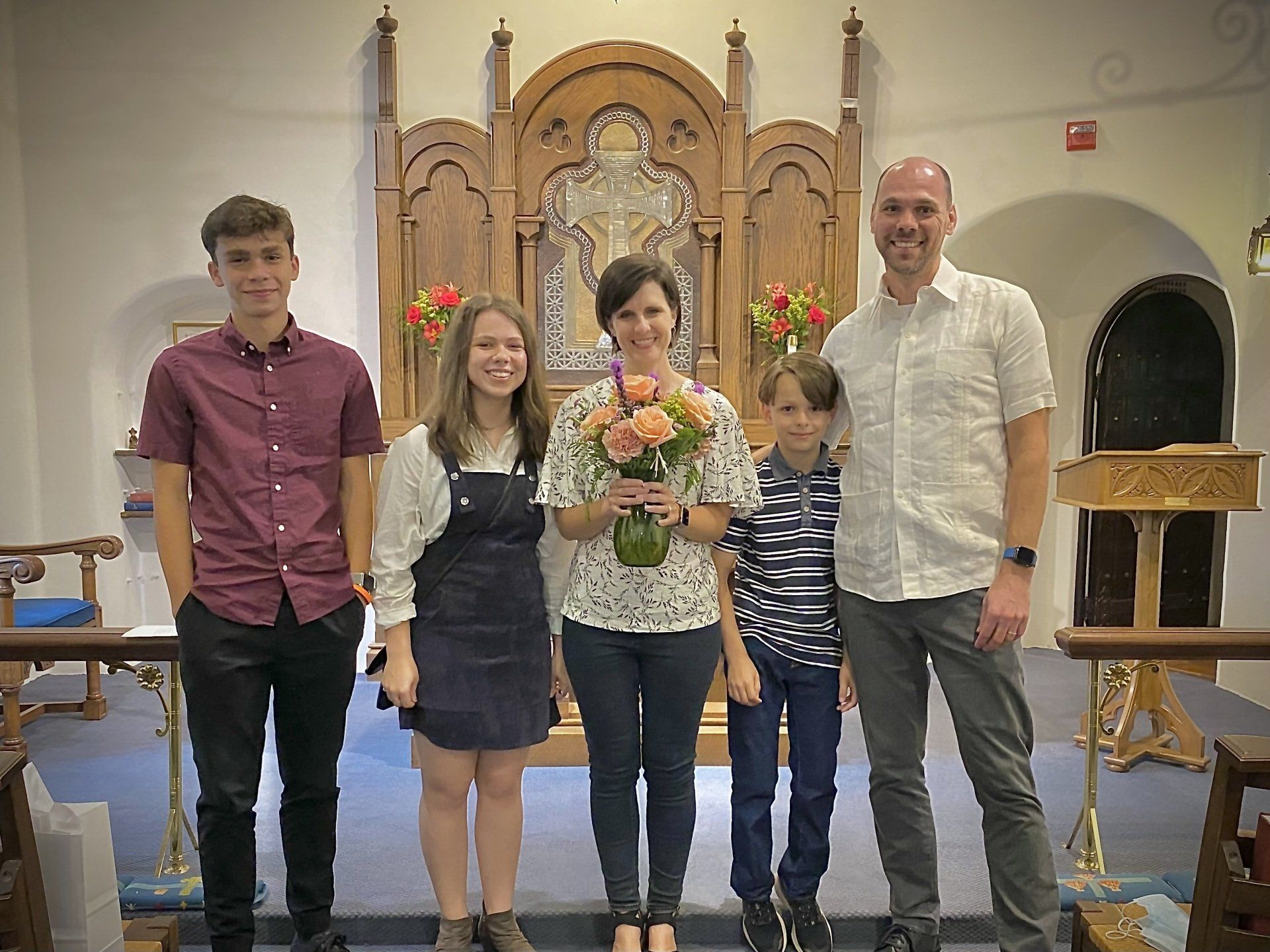 A group of people are posing for a picture in a church.