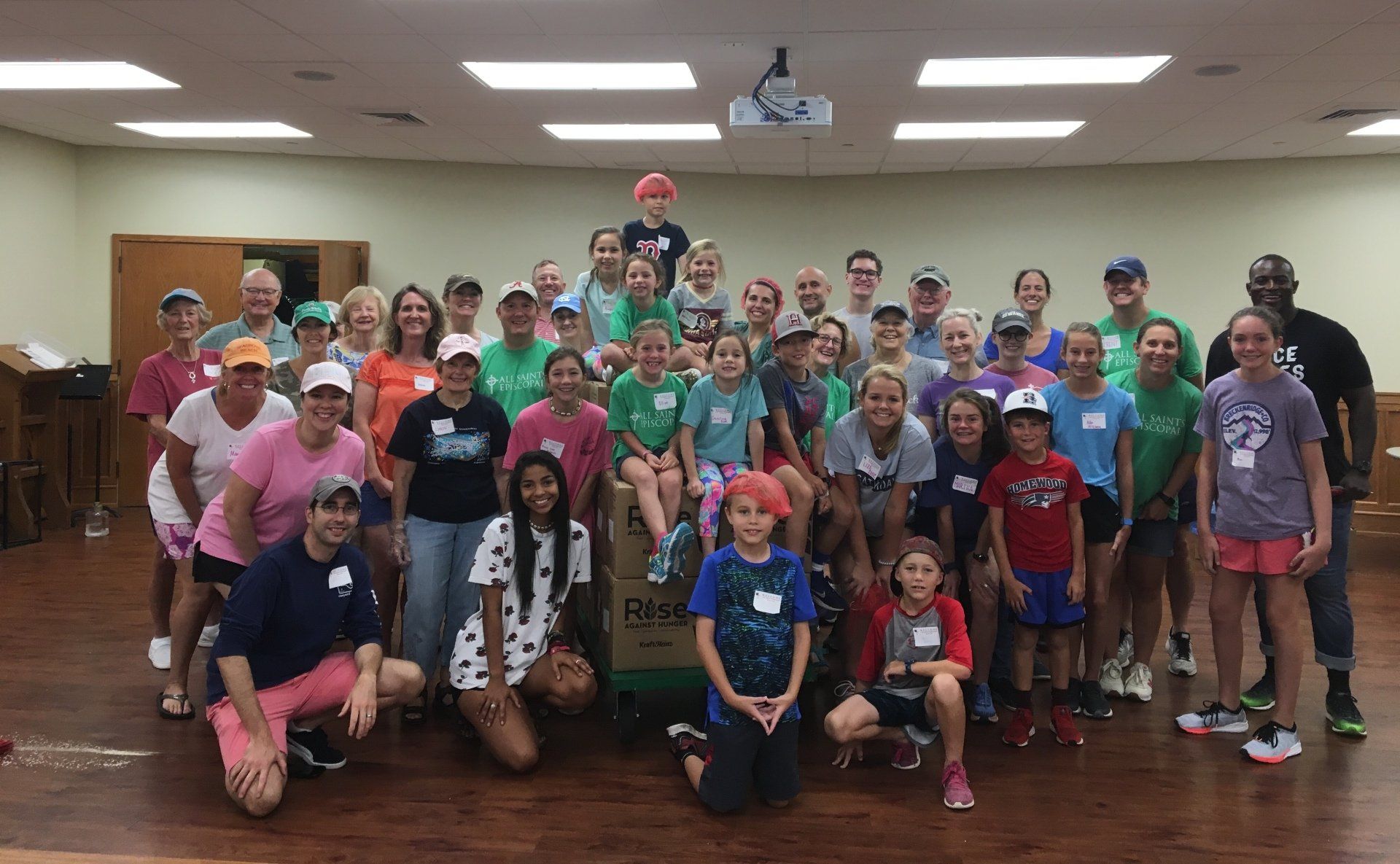 A group of people are posing for a picture in a room.