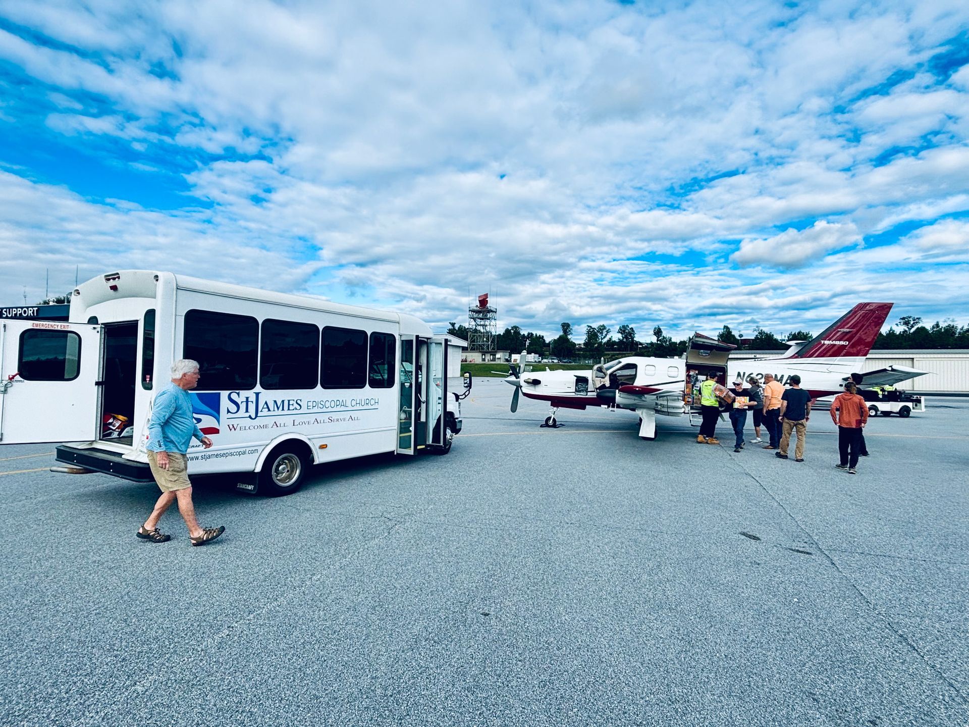 A man is walking towards a bus that says st. james on the side.