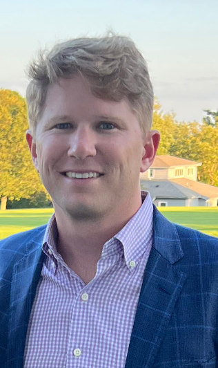 A man in a suit and tie is standing in front of an altar.
