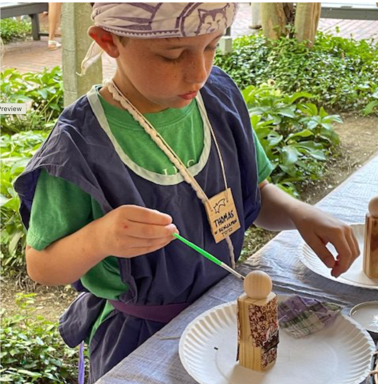 A boy wearing glasses is playing a board game