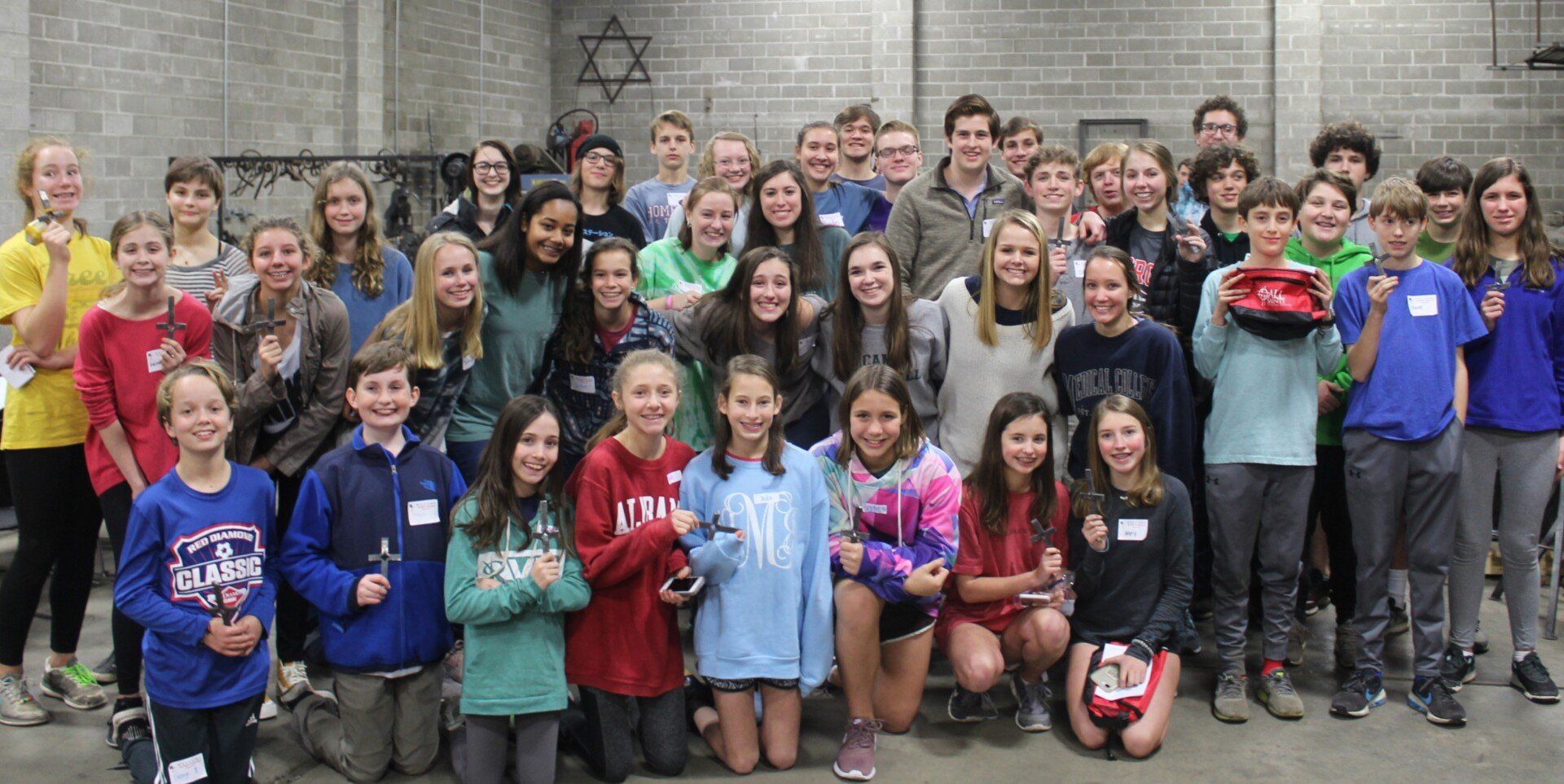 A large group of young people are posing for a picture.