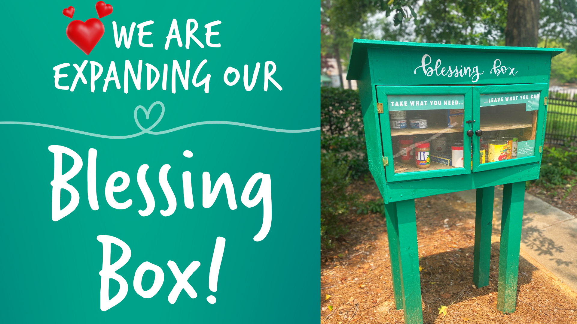 A green blessing box is sitting on a sidewalk in a park.