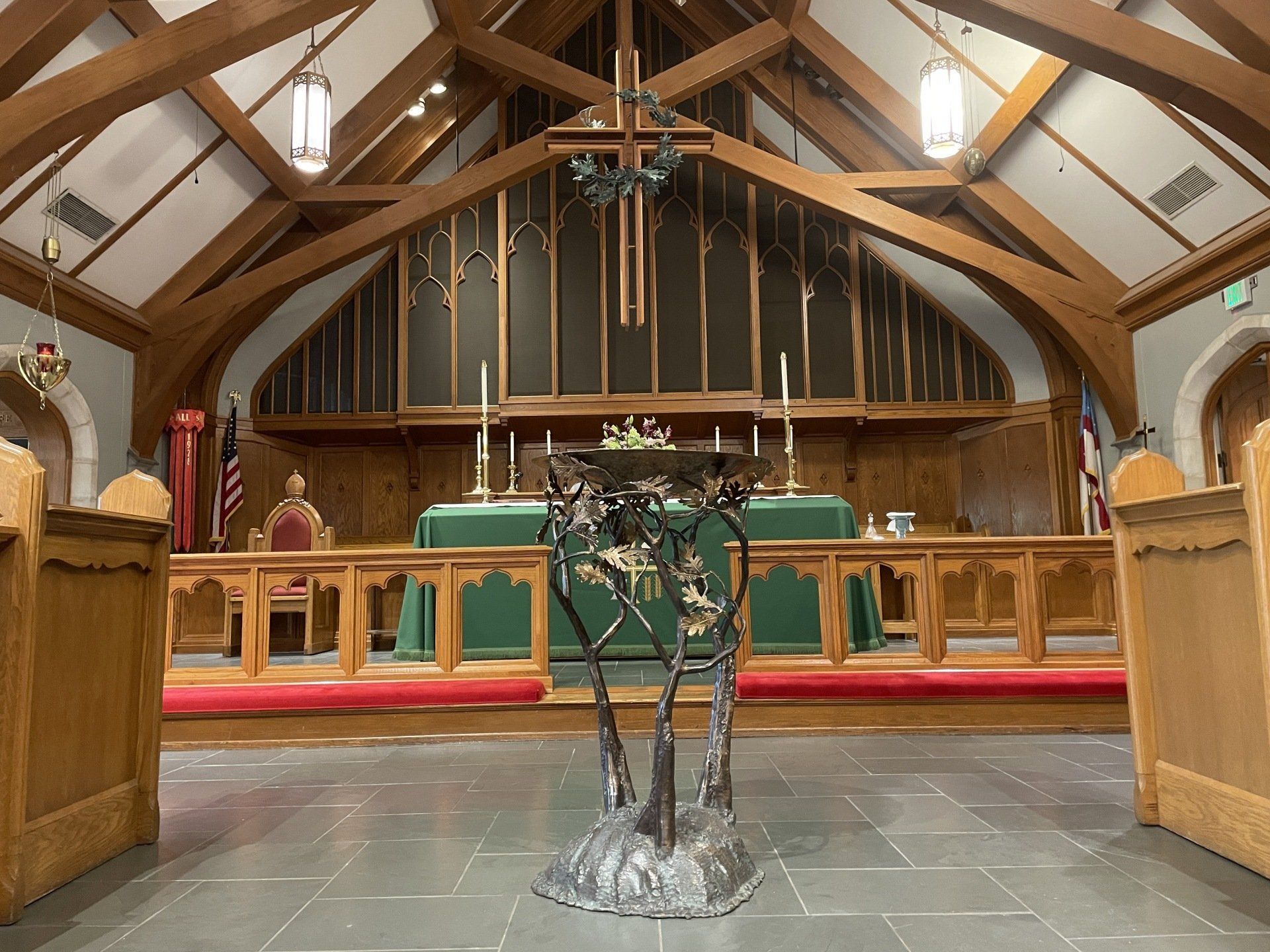 An altar in a church with a green cloth and candles