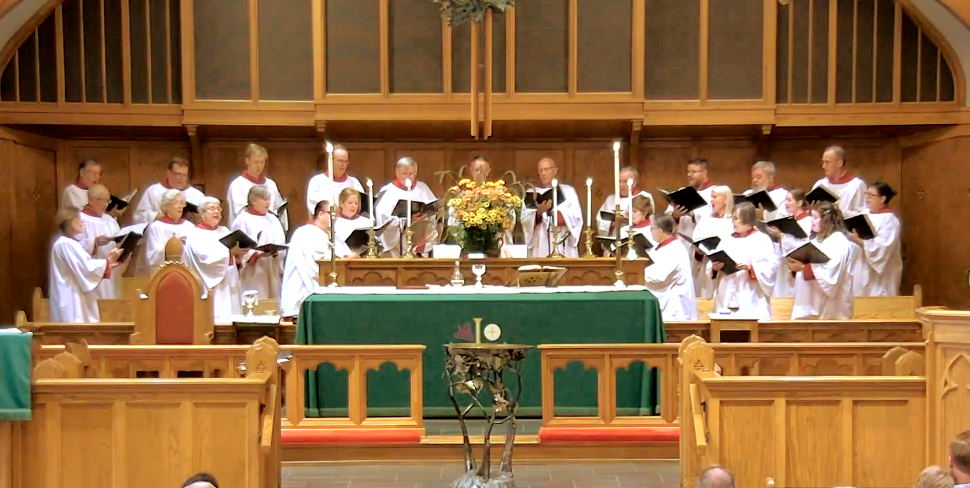 A church with a choir singing in front of the altar