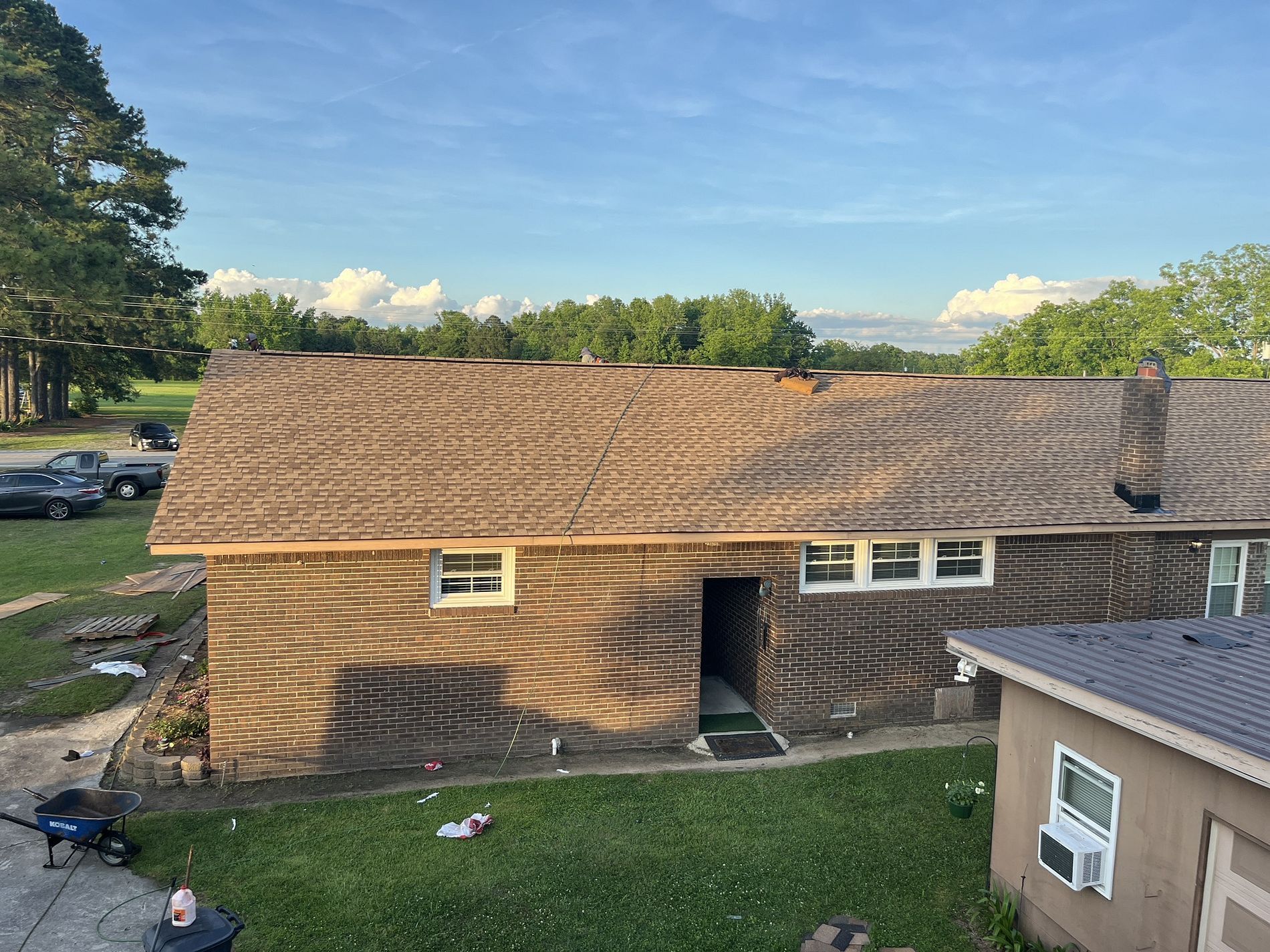 An aerial view of a house with a roof that is being remodeled.