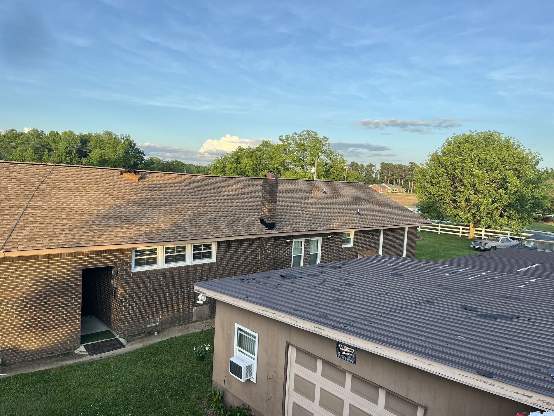 An aerial view of a house with a roof and a garage.