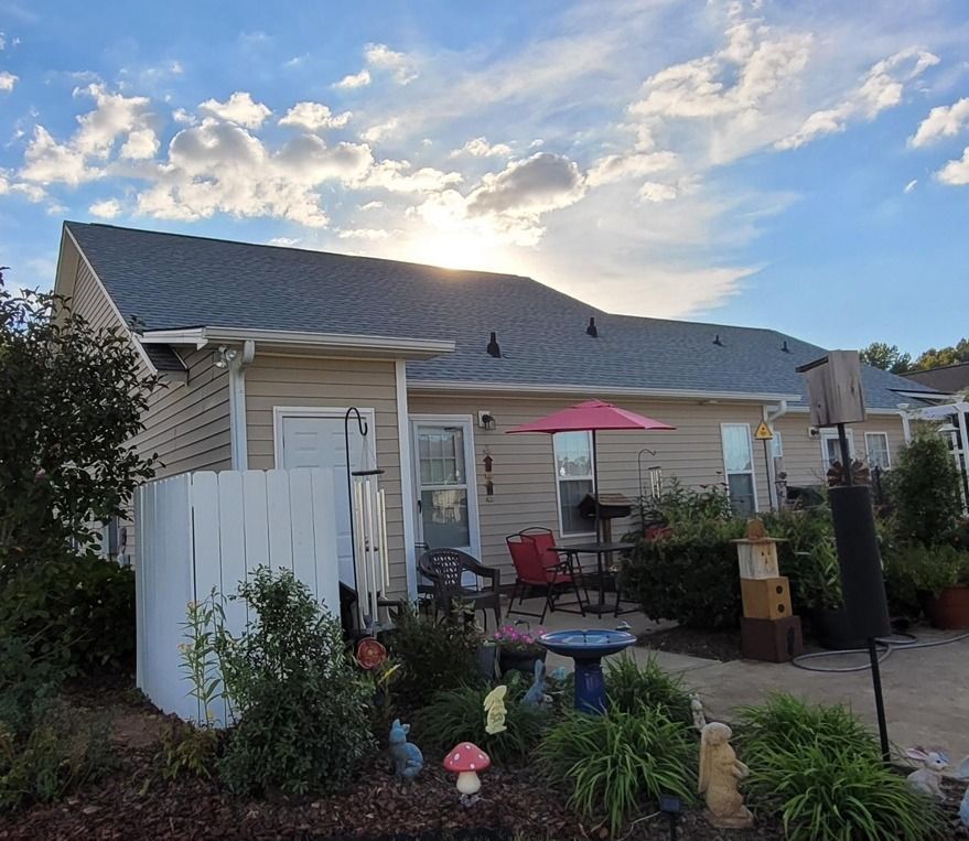 A house with a white fence and a patio area
