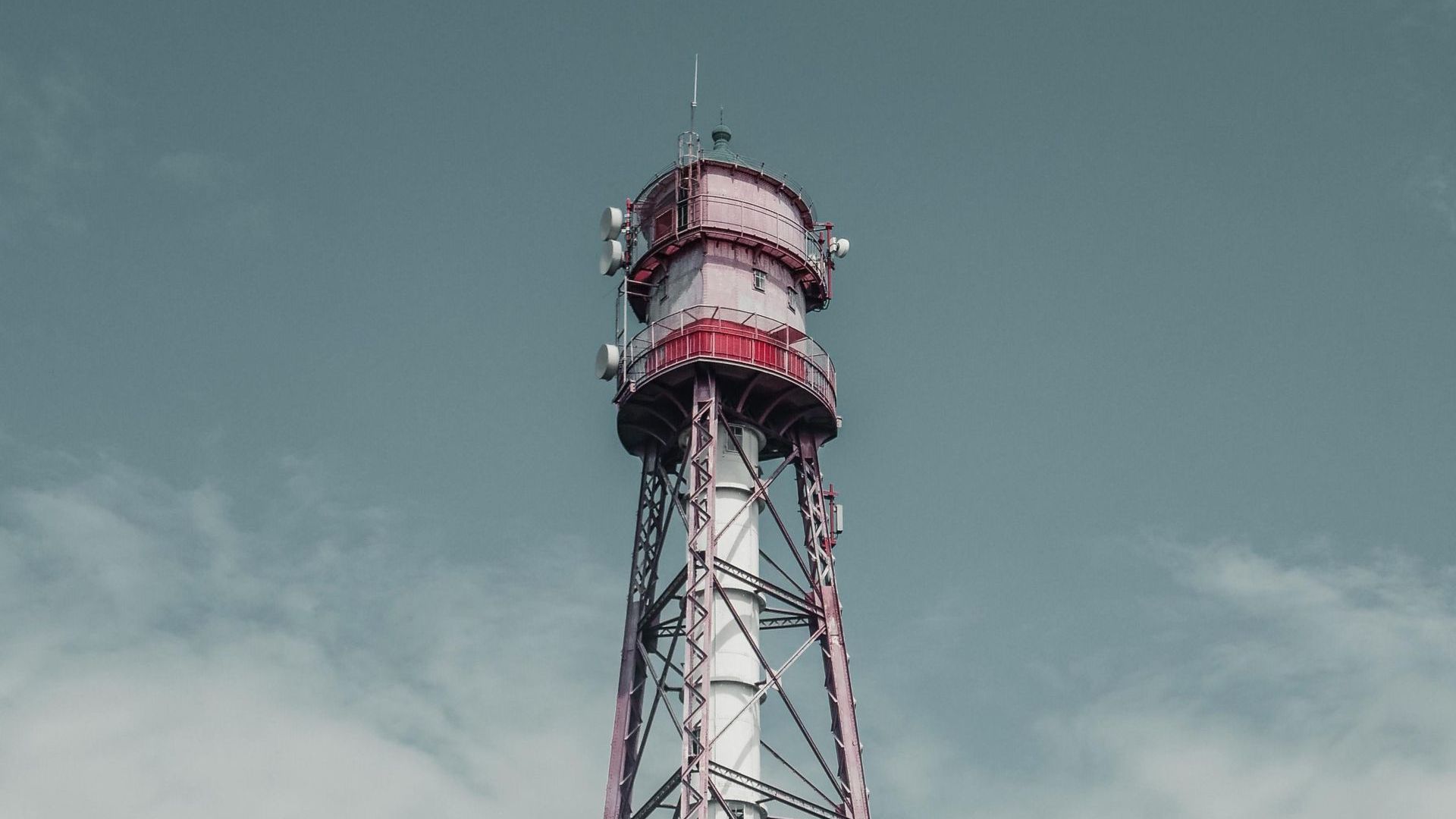 A red and white tower with a blue sky in the background.