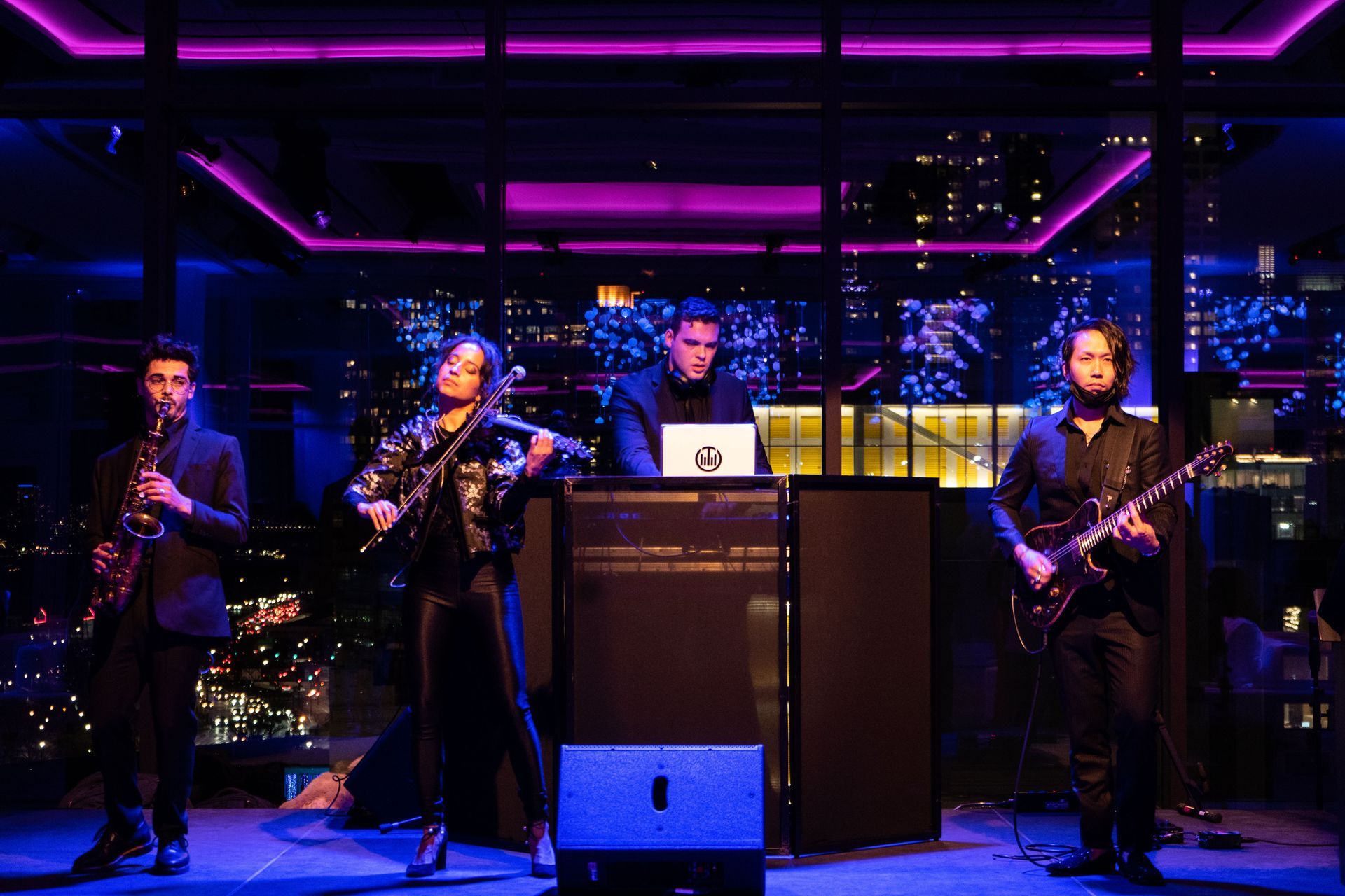A group of people are playing instruments on a stage.