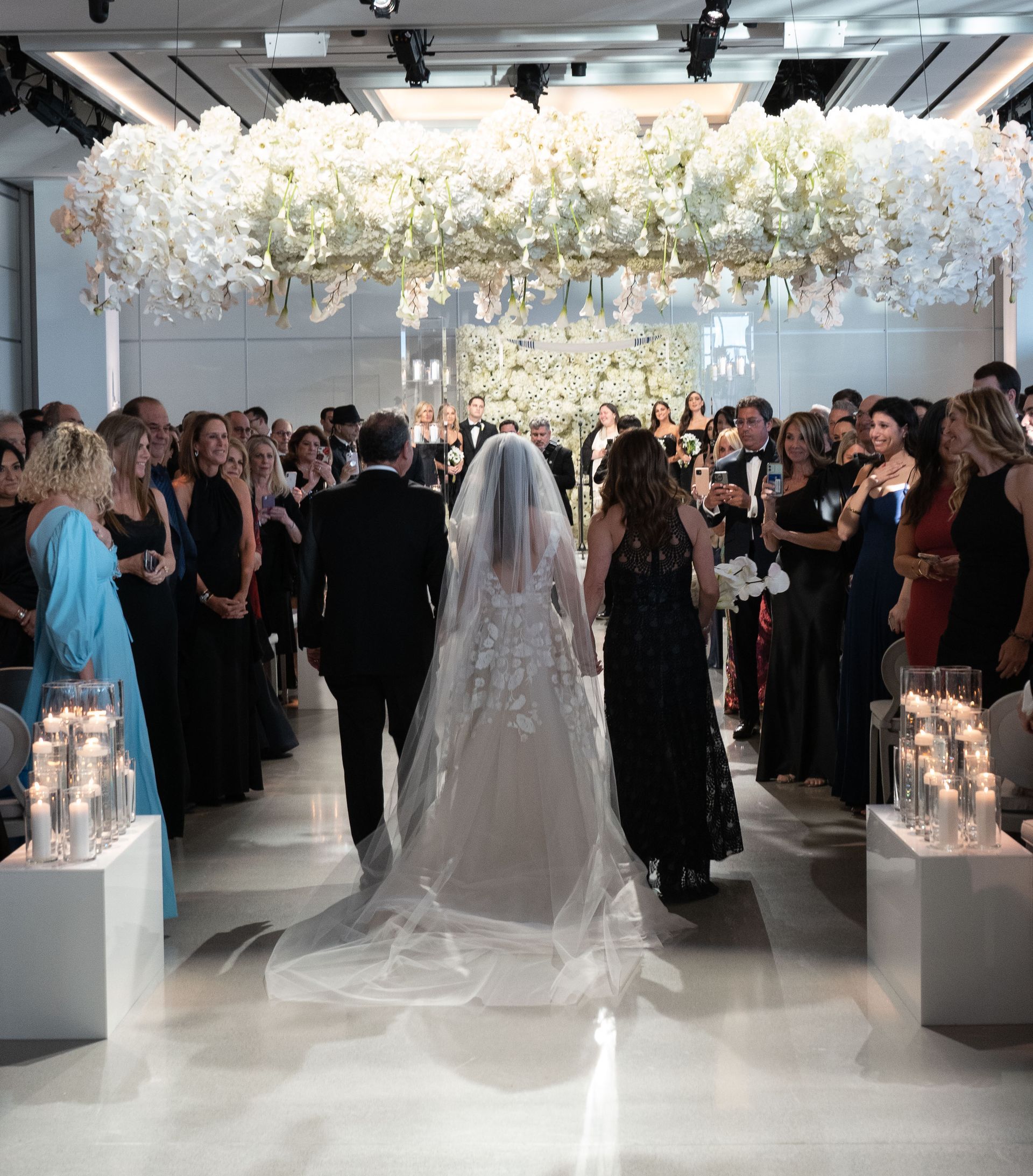A bride and groom are walking down the aisle at a wedding ceremony.