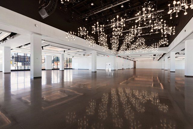 a large empty room with a lot of lights on the ceiling .