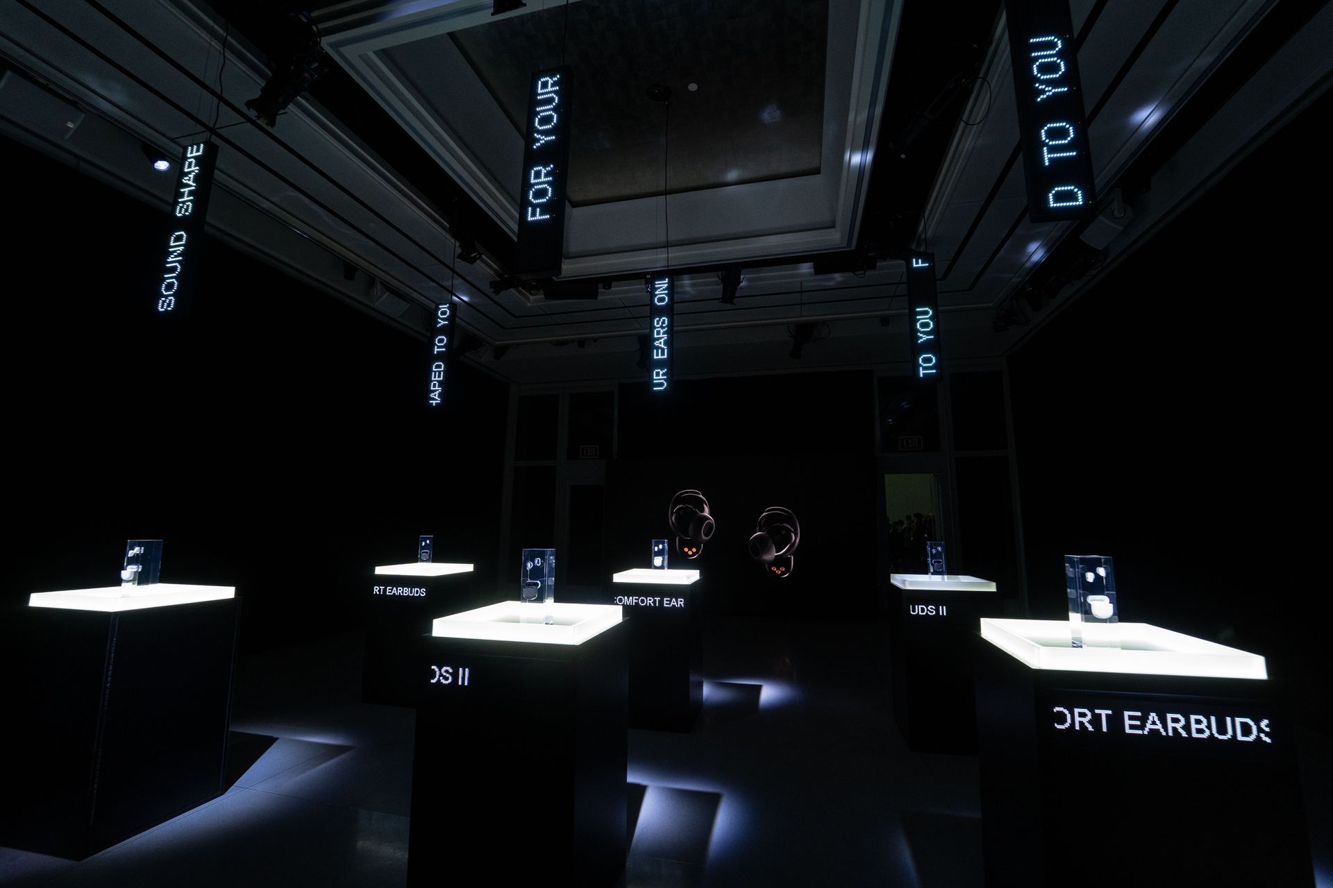A dark room with a sign that says