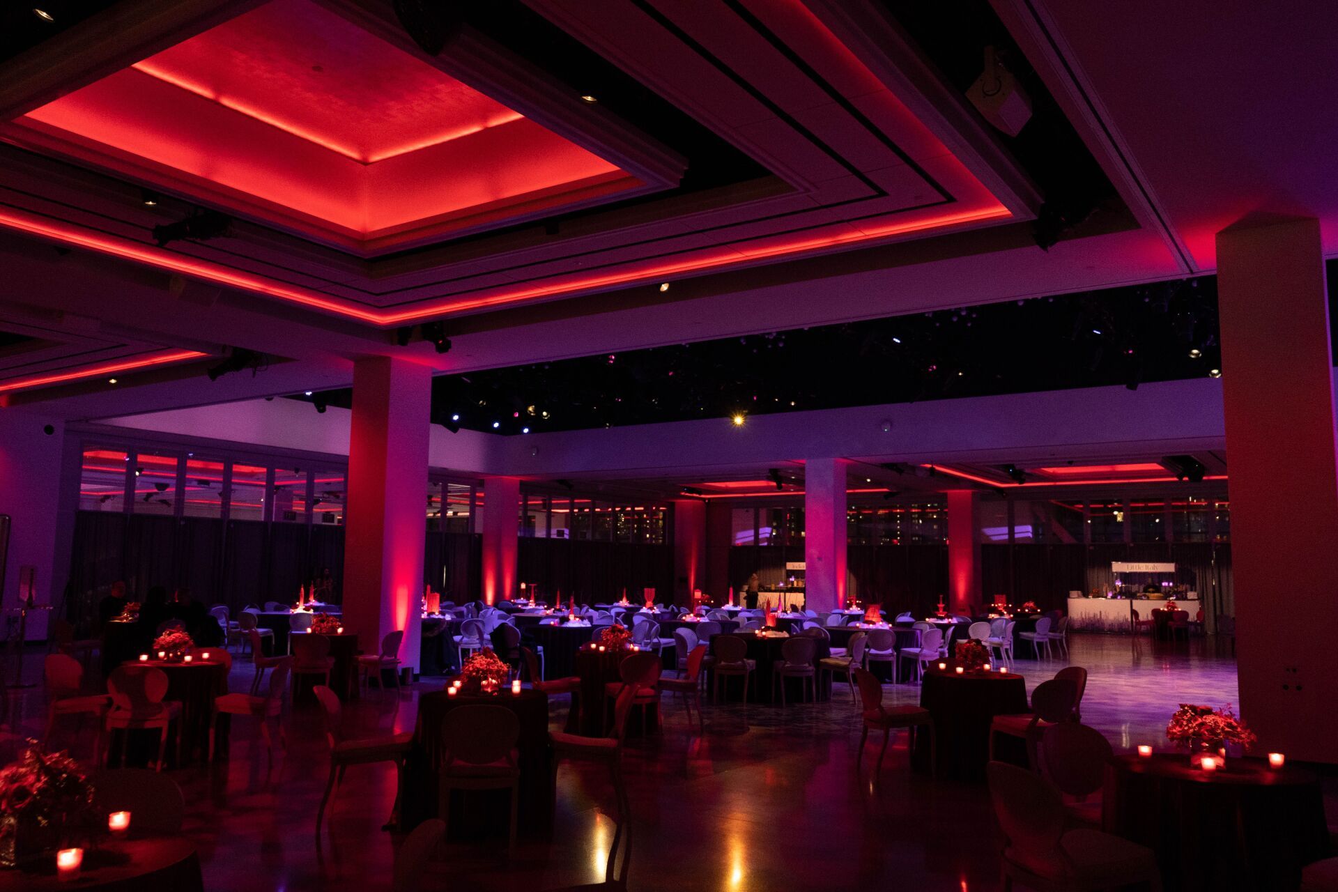 a large room with red lights on the ceiling
