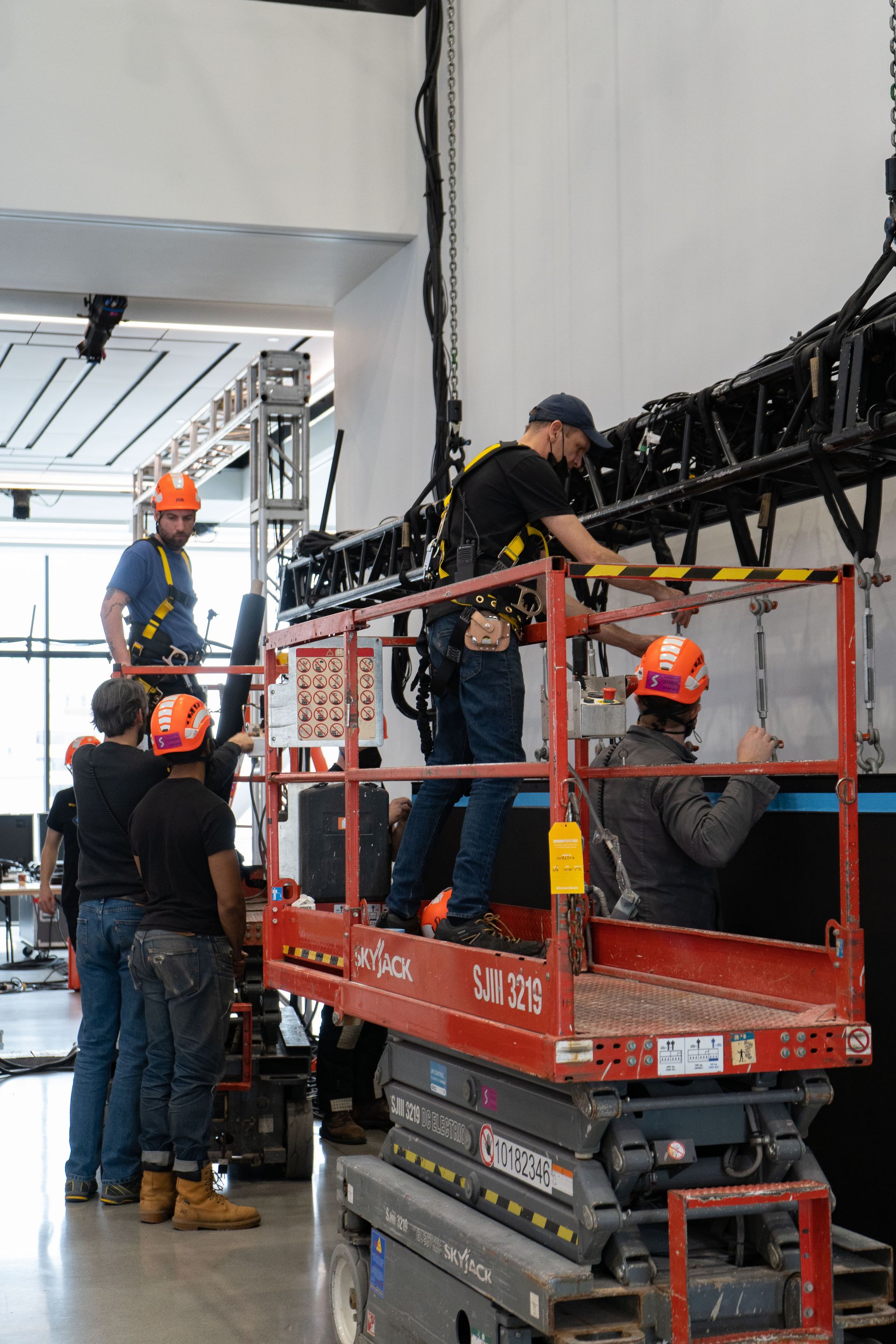 A group of men are working on a lift in a building.