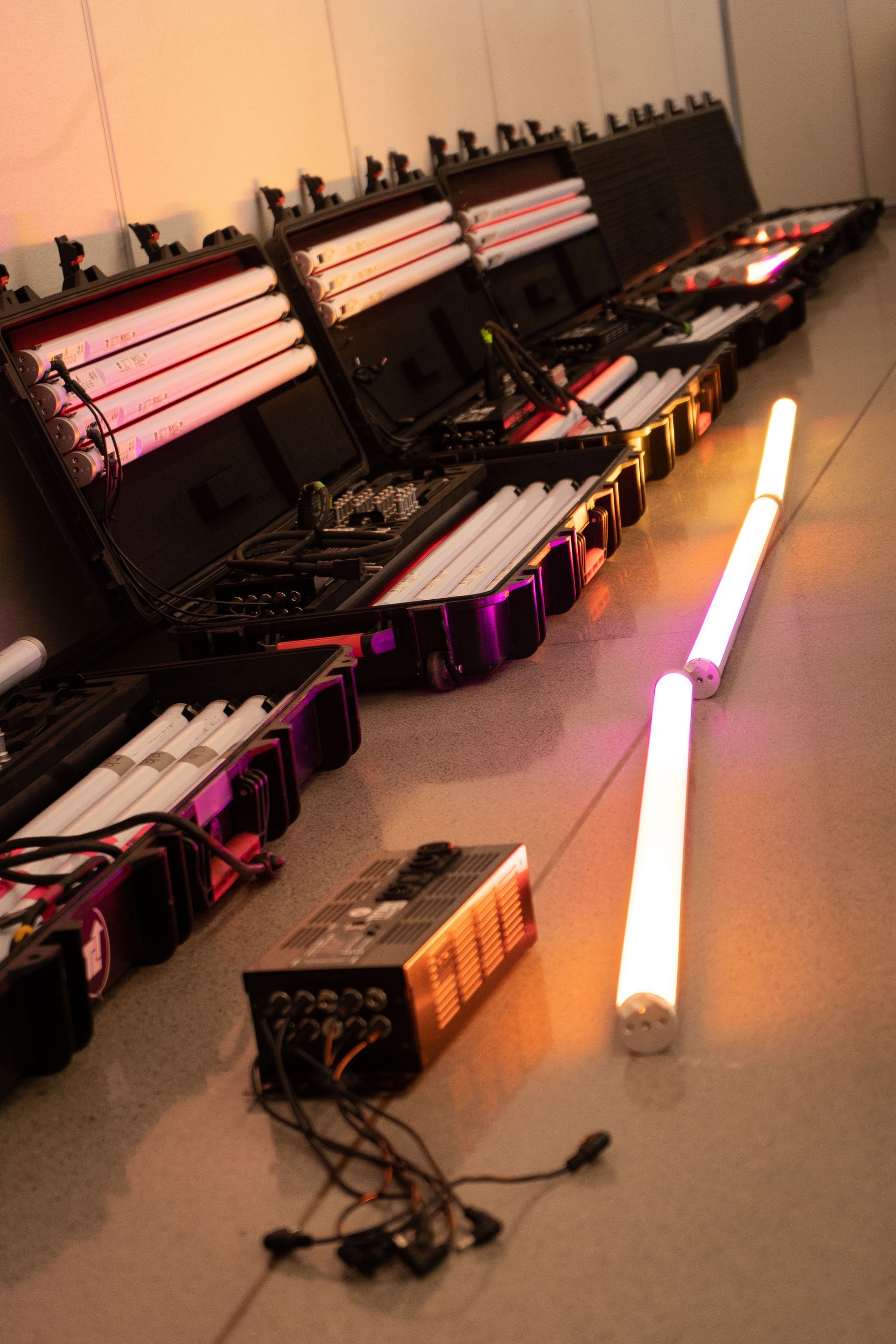 A bunch of lights are lined up on the floor