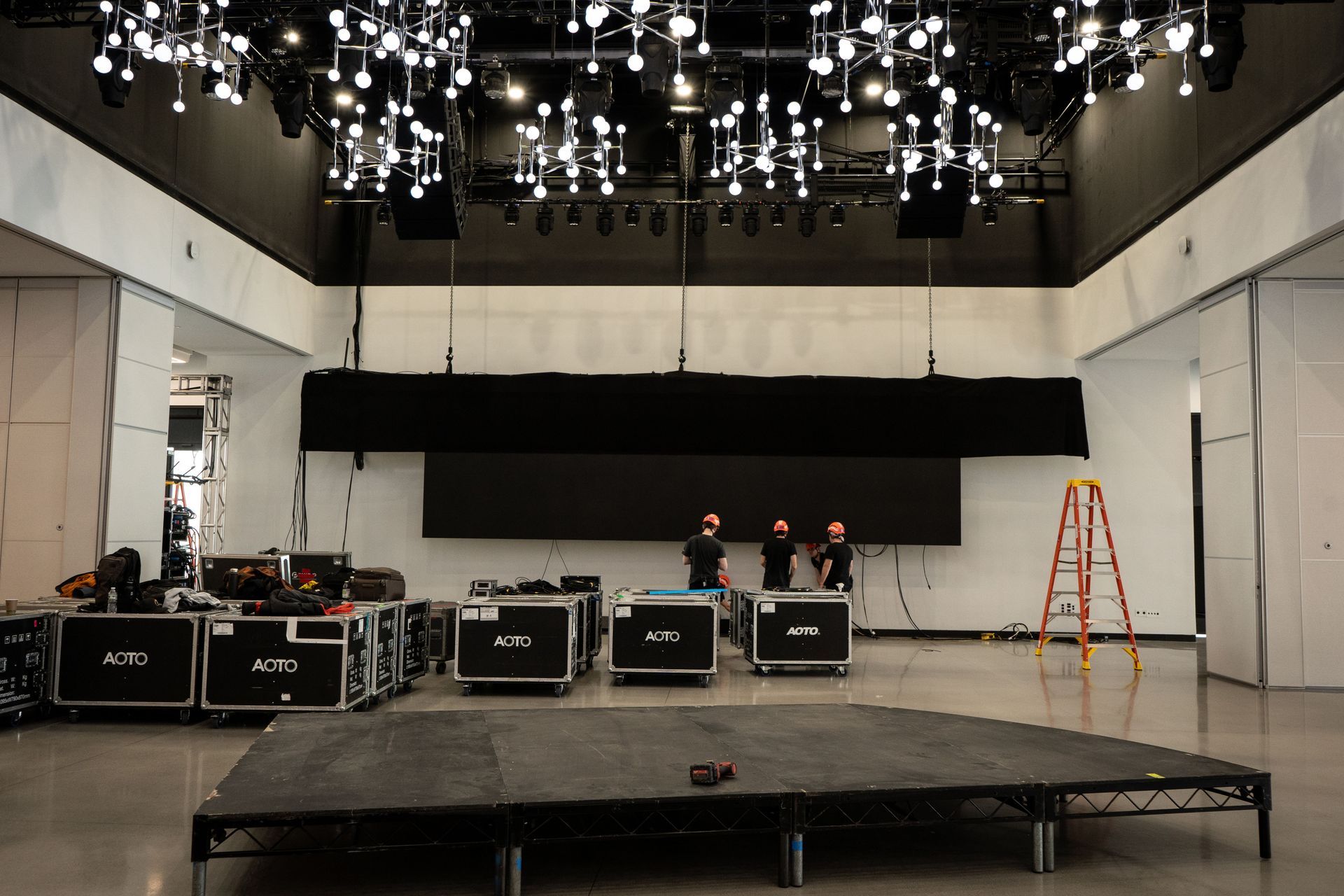 A stage is being set up in a large room