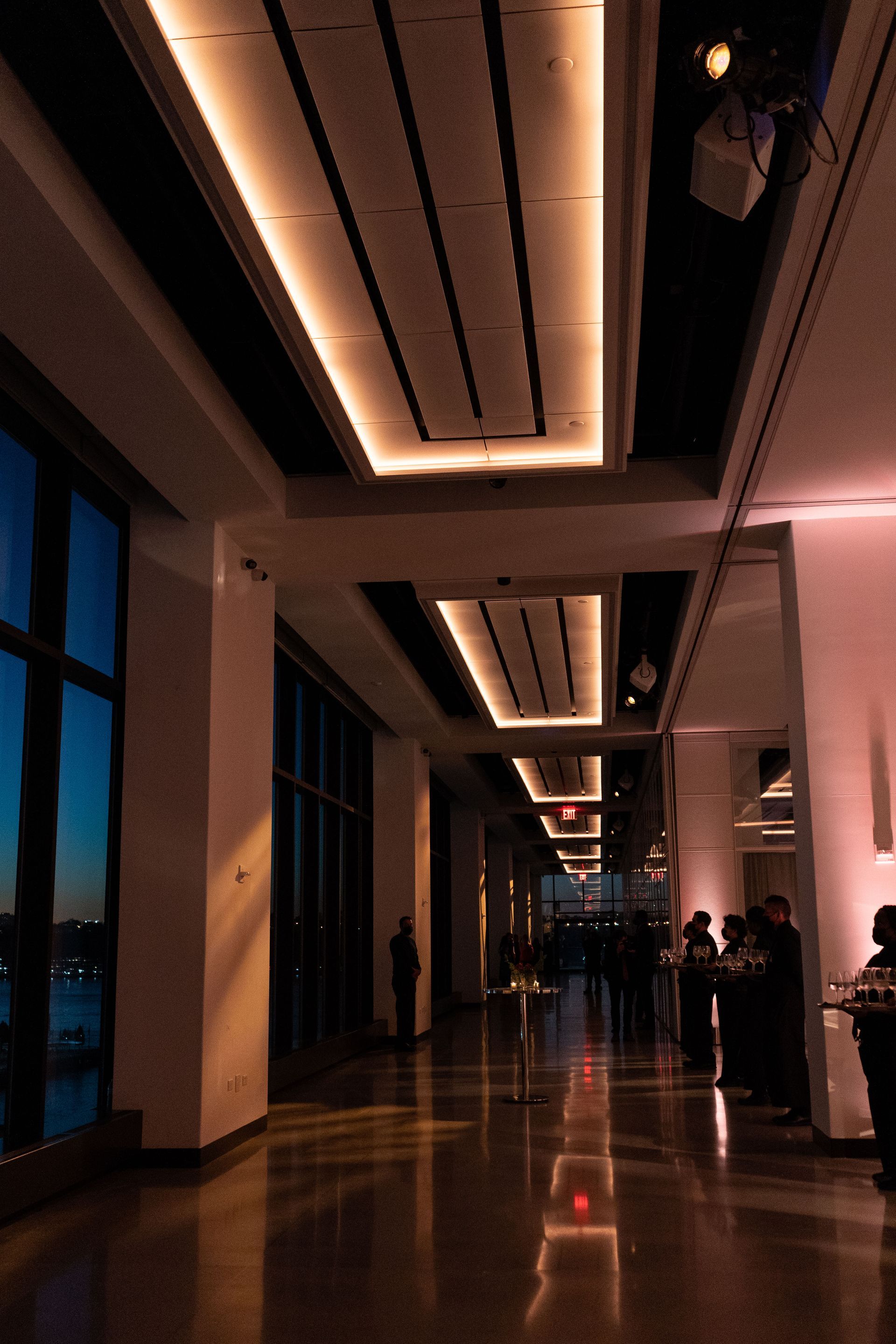 A long hallway with a ceiling that is lit up at night
