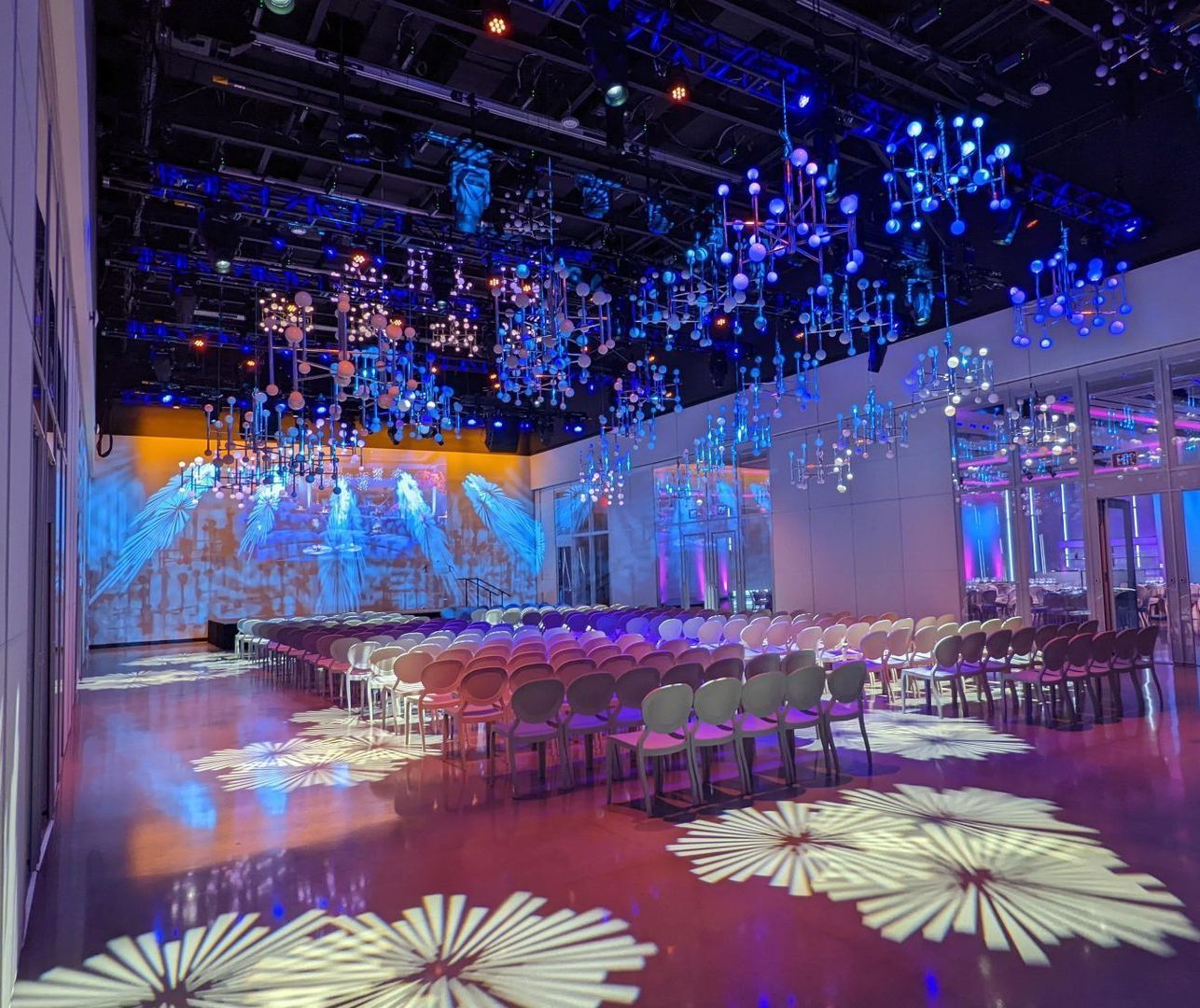a large room with a lot of chairs and lights on the ceiling .
