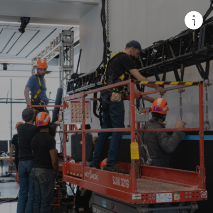 A group of men are working on a lift that says sjm 3218