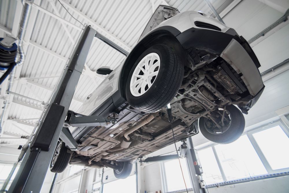 A Car is Sitting on a Lift in a Garage — P & R Automotive Services in Pialba, QLD 