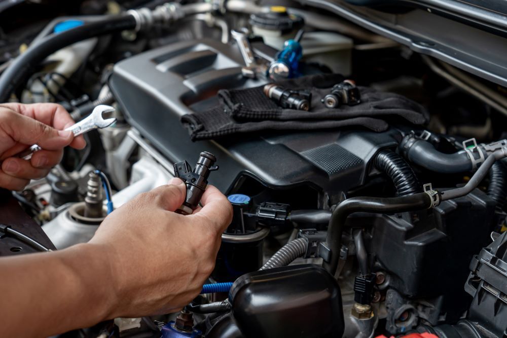 A Person is Working on a Car Engine With a Wrench — P & R Automotive Services in Pialba, QLD 