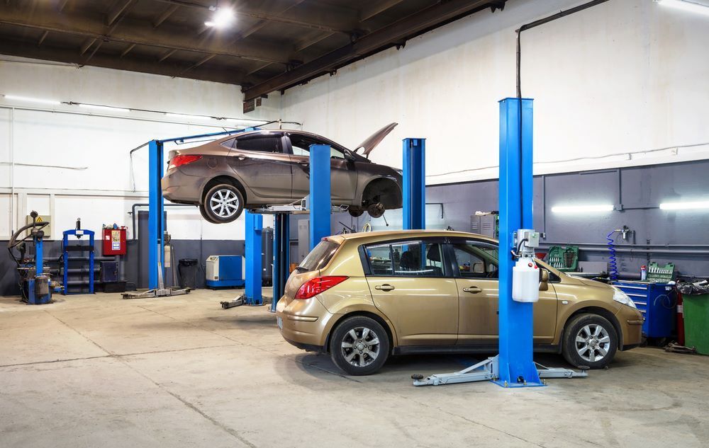 A Car is Sitting on a Lift in a Garage — P & R Automotive Services in Pialba, QLD 