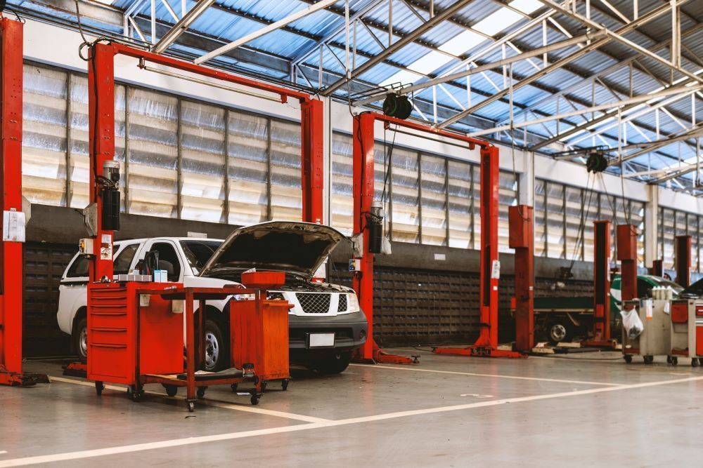 A Car is Sitting on a Lift in a Garage — P & R Automotive Services in Pialba, QLD 