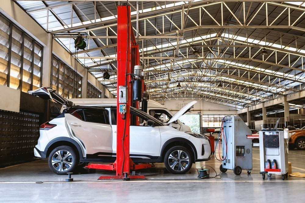 A Car is Sitting on a Lift in a Garage — P & R Automotive Services in Pialba, QLD 