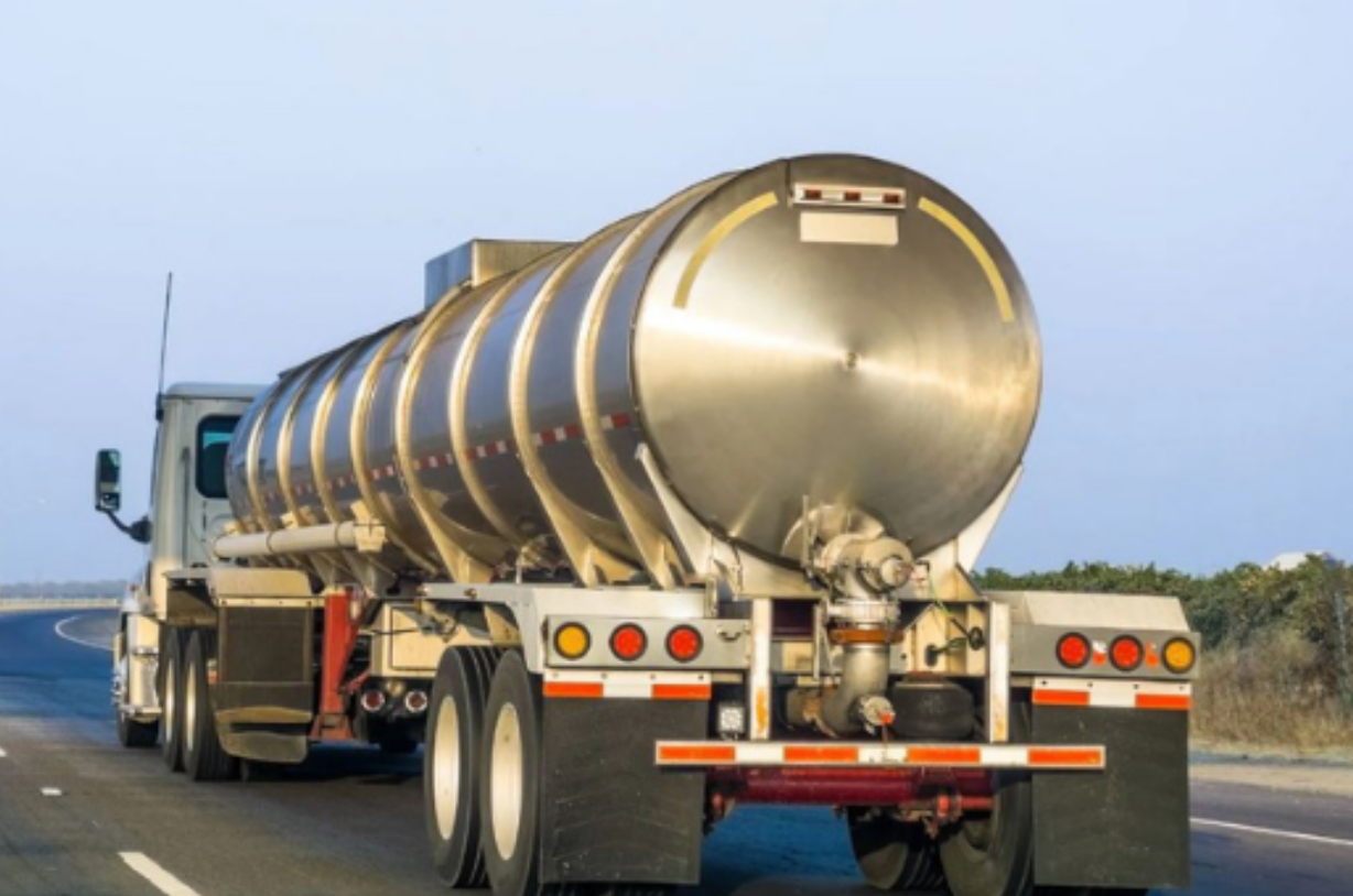 A tanker truck is driving down a highway.