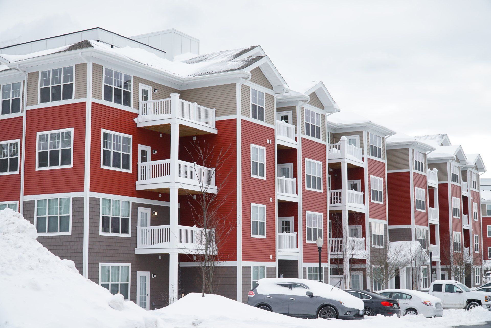 apartment complex covered in snow and in need of snow removal