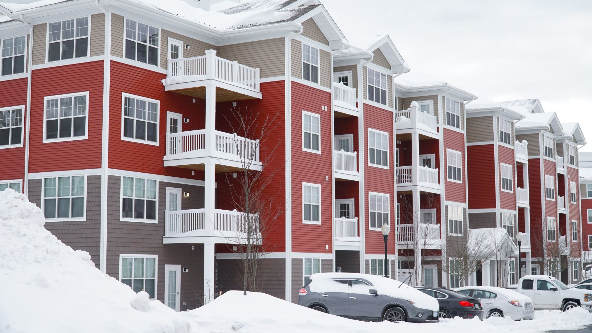 apartment complex covered in snow and in need of snow removal