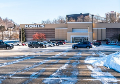a retail store covered in snow and in need of commercial snow removal