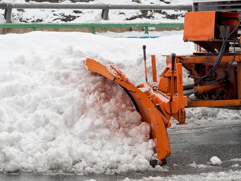 A commercial snow removal contractor plows snow.