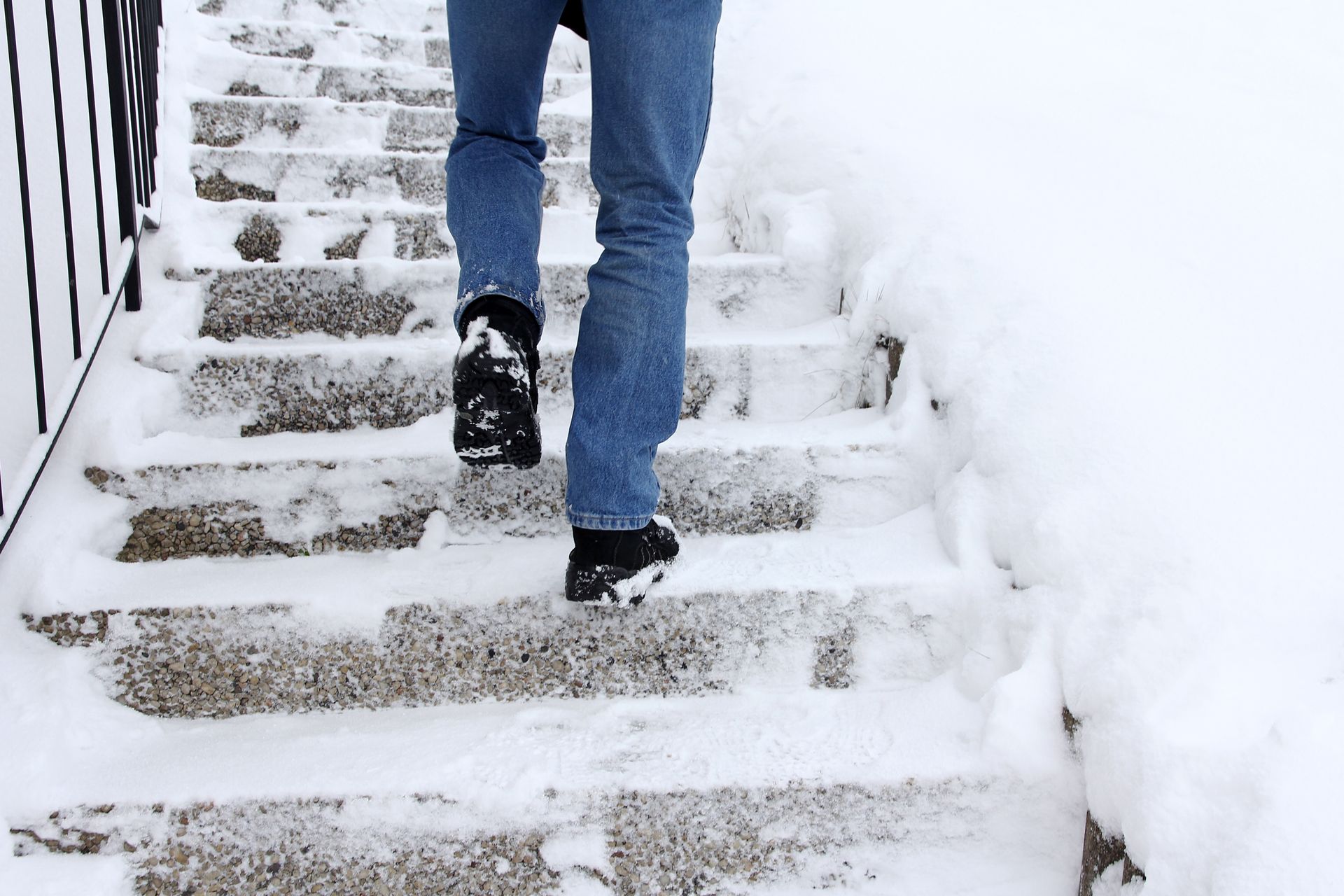 a man walking up steps covered in snow