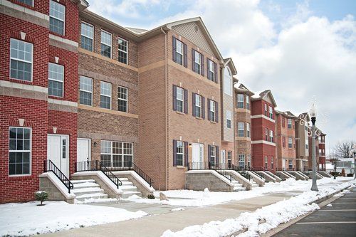 a condominium complex covered in snow and in need of commercial snow removal
