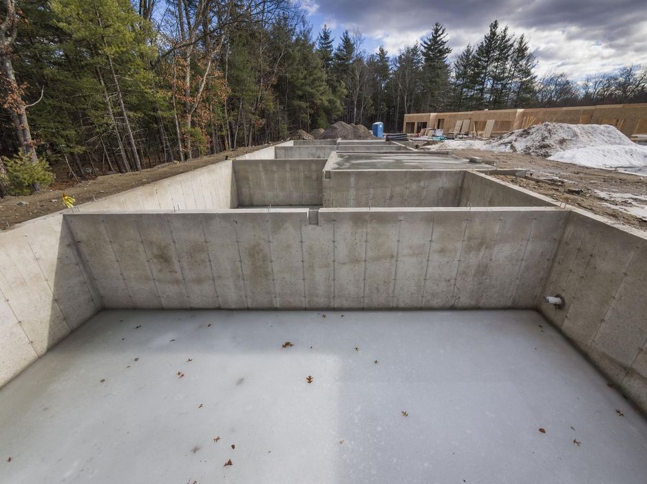 a large concrete structure with a lot of snow on the ground