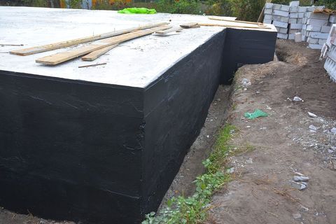 a black box sitting on top of a dirt field
