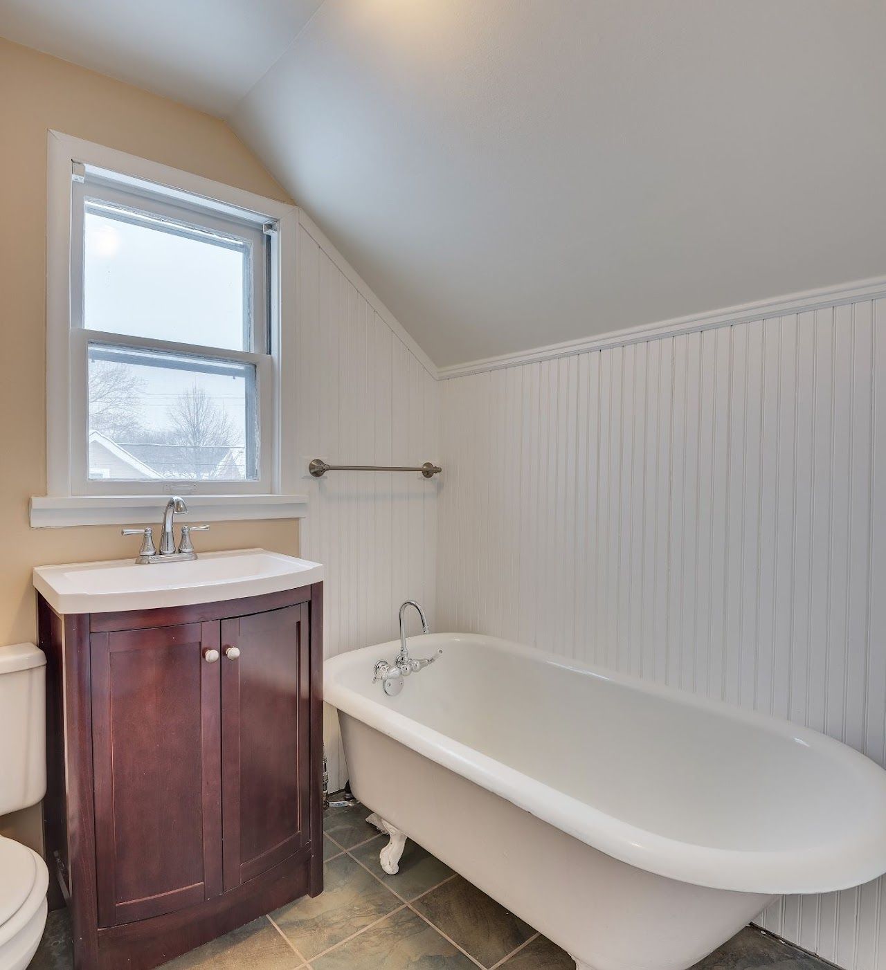 A bathroom with a tub a sink and a toilet