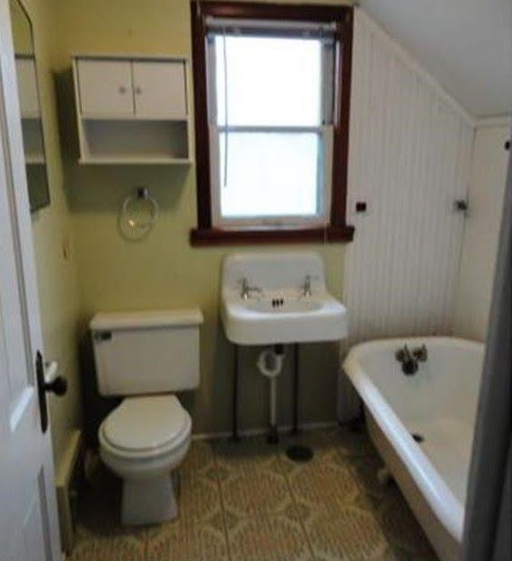 A bathroom with window, a toilet sink and bathtub