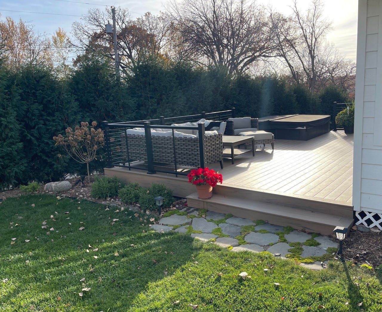 A deck with a hot tub and a couch on it