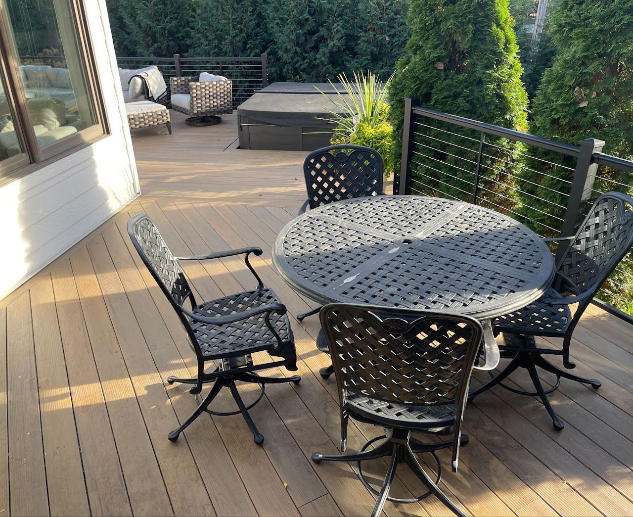 A wooden deck with a table and chairs on it