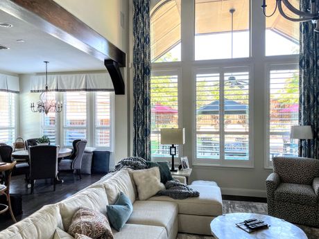 A living room with a couch , chairs , and a table.