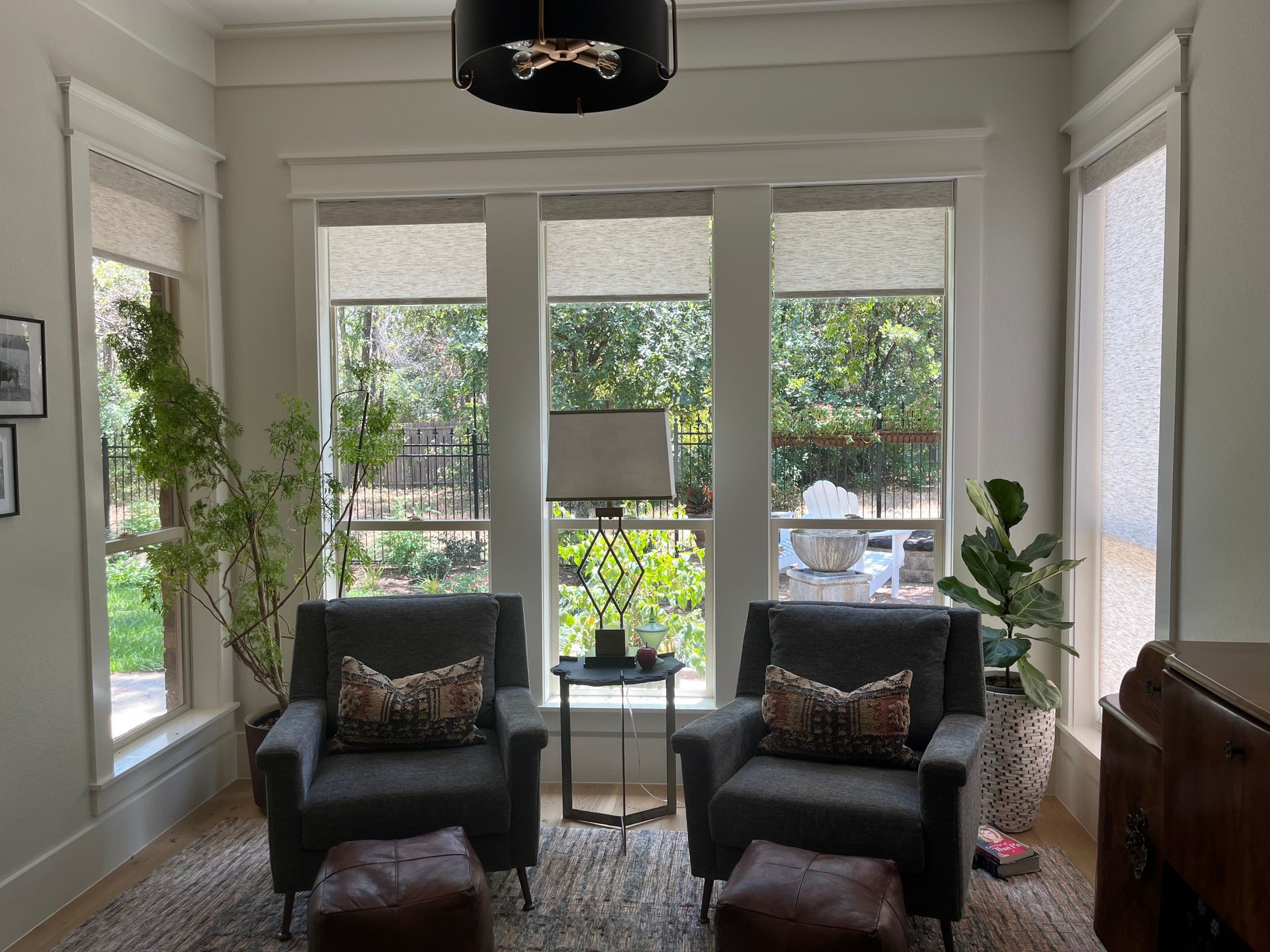 A living room with two chairs and two ottomans
