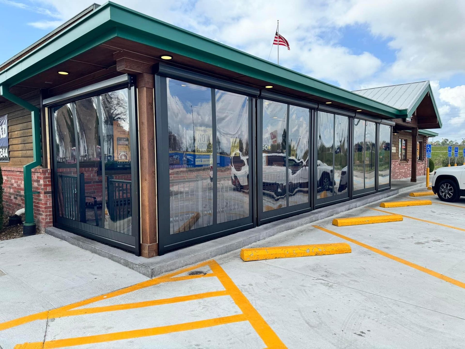 A large building with a lot of windows and a truck parked in front of it.