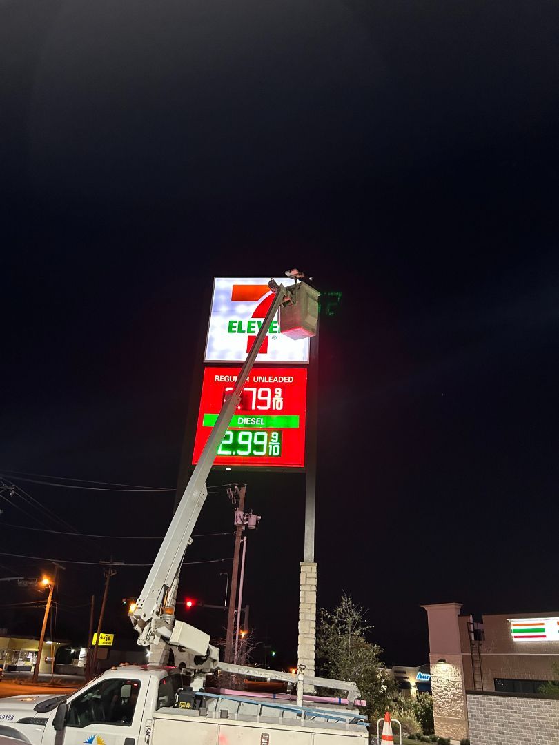 A neon sign for 7 eleven is lit up at night