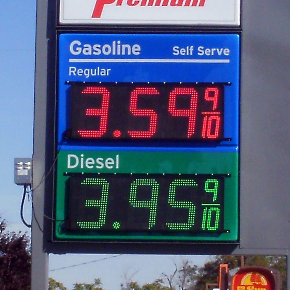 A 7 eleven gas station with a truck parked in front of it.